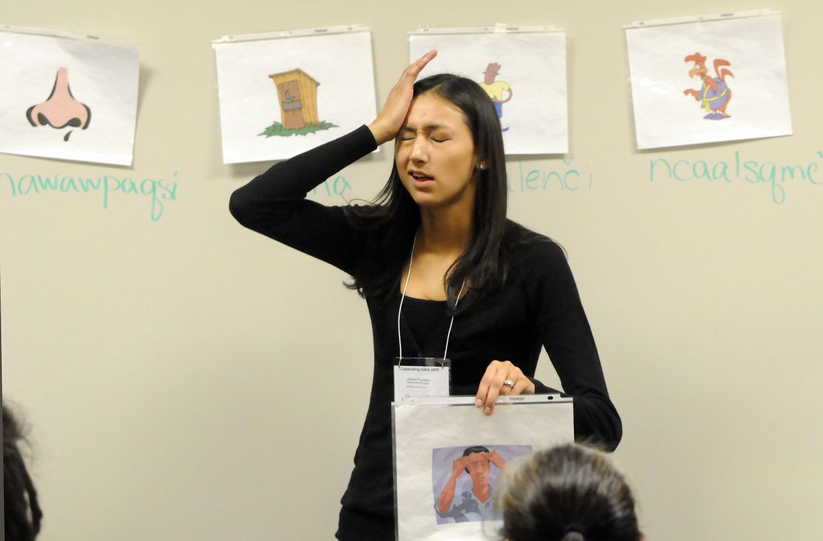 Jesse Fountain, a language teacher from the Kalispel Tribe, pantomimes a headache as she teaches a Salish language lesson about words for health problems in a class Thursday at Spokane Falls Community College, part of an intertribal conference on the  Salish language. (Photos by Jesse Tinsley / The Spokesman-Review)