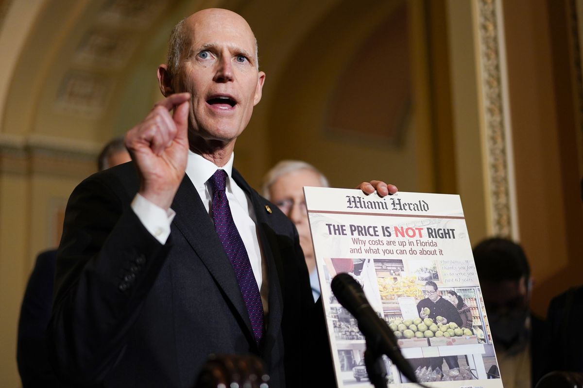 Sen. Rick Scott, R-Fla., holds a printed out copy the Miami Herald newspaper during a news conference after a weekly Republican policy luncheon on Capitol Hill in Washington, Tuesday, Dec. 7, 2021.  (Carolyn Kaster)