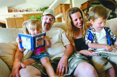 
Parents as Teachers, cut from the state budget, has helped Erik and Zeyda Foreman with parenting and teaching skills for their 3-year-old twins, Erika and Kaden. 
 (Jesse Tinsley / The Spokesman-Review)