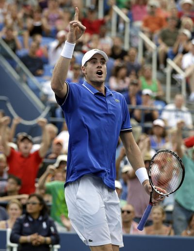 John Isner tries to get the crowd involved at Flushing Meadows. (Associated Press)