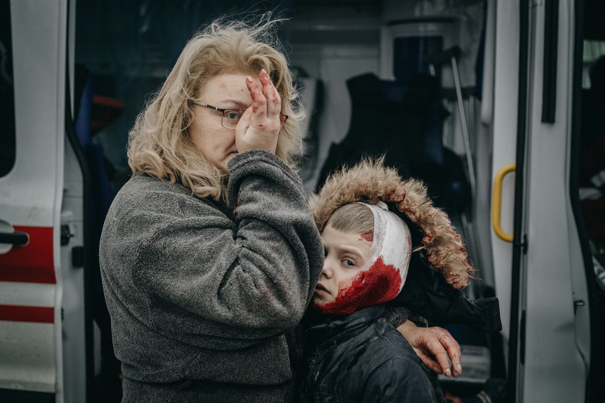 Mariana Vlasliuk holds son Sasha, who was wounded in a strike on apartment buildings in the city center of Kharkiv, Ukraine, on Tuesday.  (Wojciech Grzedzinski/for The Washington Post)