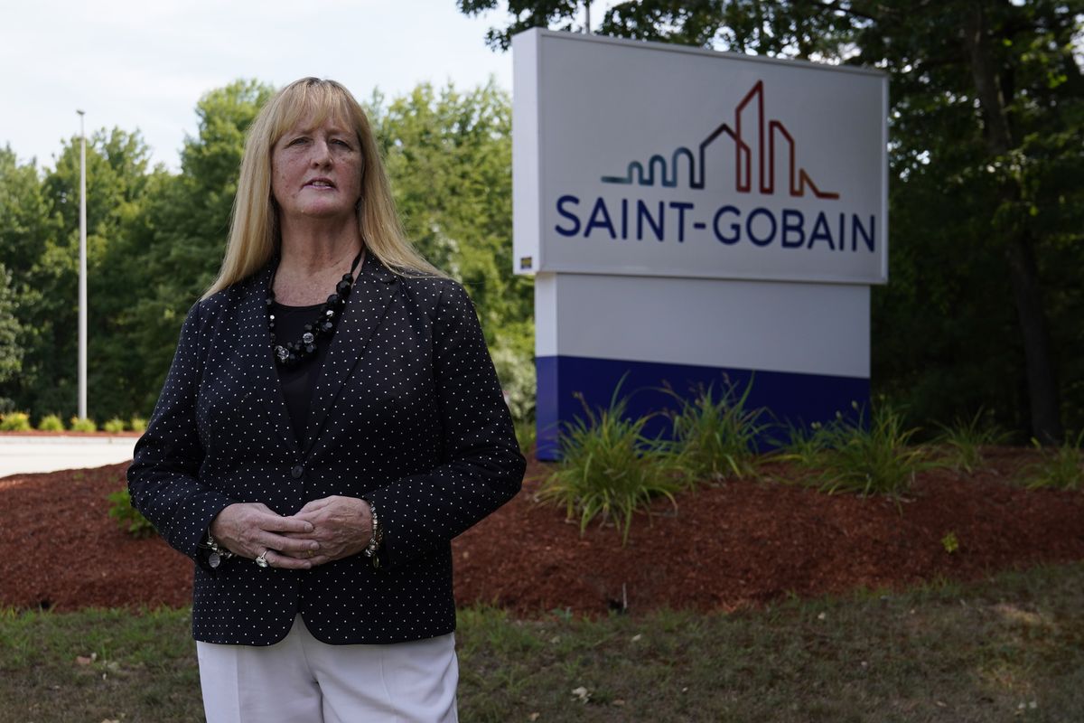 In this Friday, Aug. 14, 2020, photo New Hampshire Rep. Nancy Murphy, D-Merrimack, poses for a photo outside the Saint-Gobain plastics factory in Merrimack, N.H. (Charles Krupa)