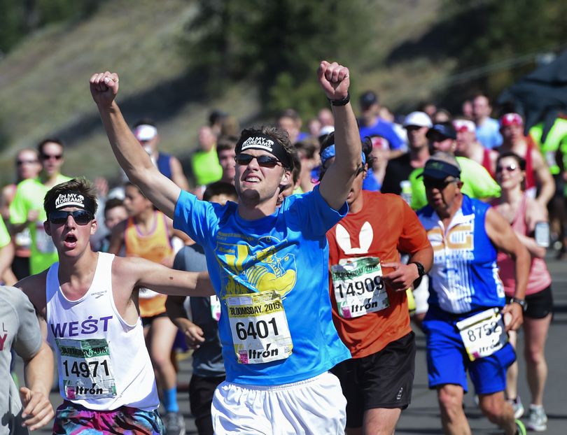 Kevin Ward, center, celebrates after cresting Doomsday Hill – and reaching the 5-mile marker – during Bloomsday 2015 on Sunday. (Tyler Tjomsland)