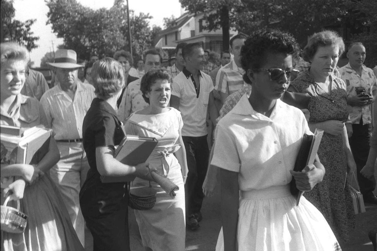 Hazel Bryan, center, her face twisted in anger, is part of the crowd taunting Elizabeth Eckford, right foreground, on Sept. 4, 1957, as she walks in front of Central High School in Little Rock on Sept. 4, 1957.  (WILL COUNTS/Arkansas Democrat via AP)