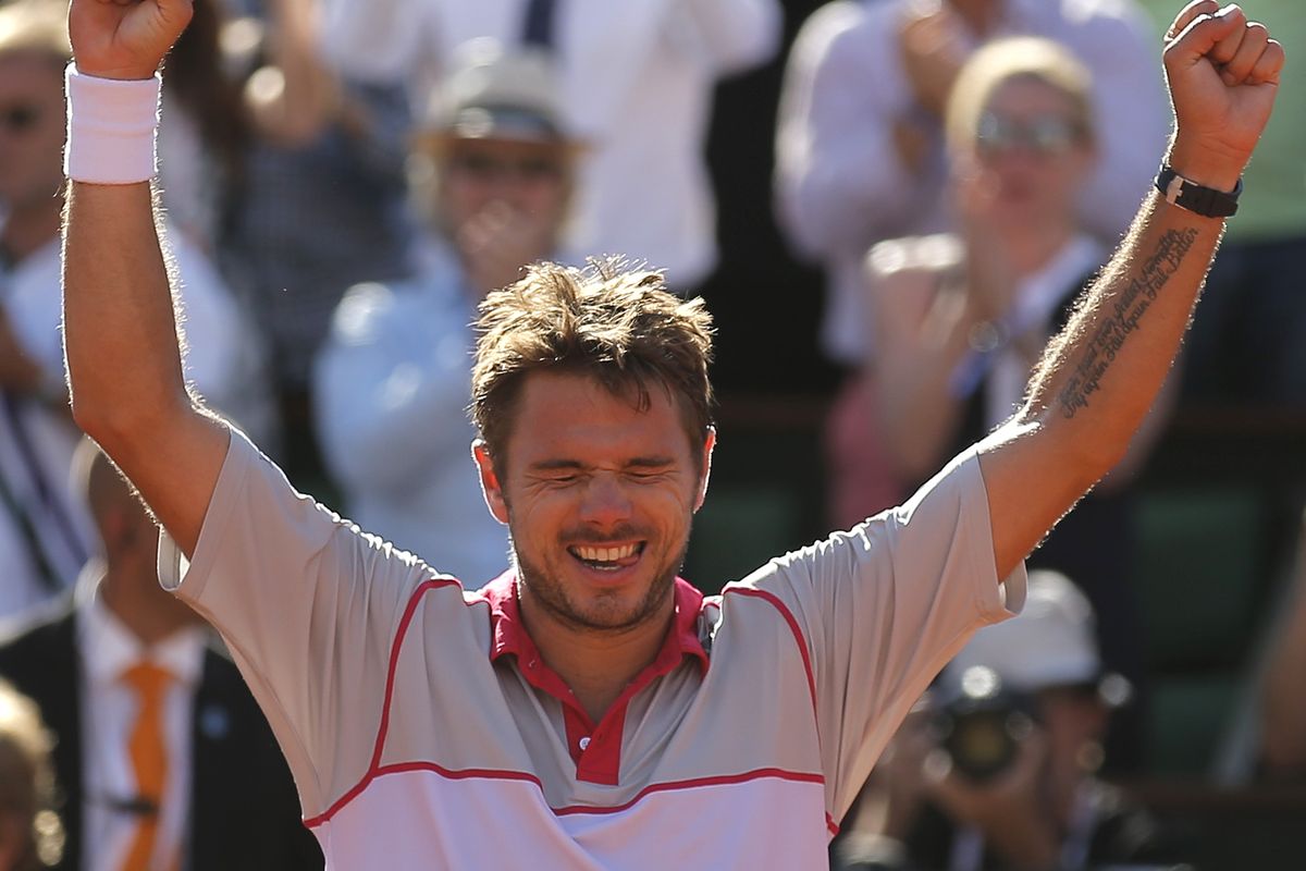 Switzerland’s Stan Wawrinka raises arms in victory after defeating Serbia’s Novak Djokovic in the French Open men’s singles final. (Associated Press)