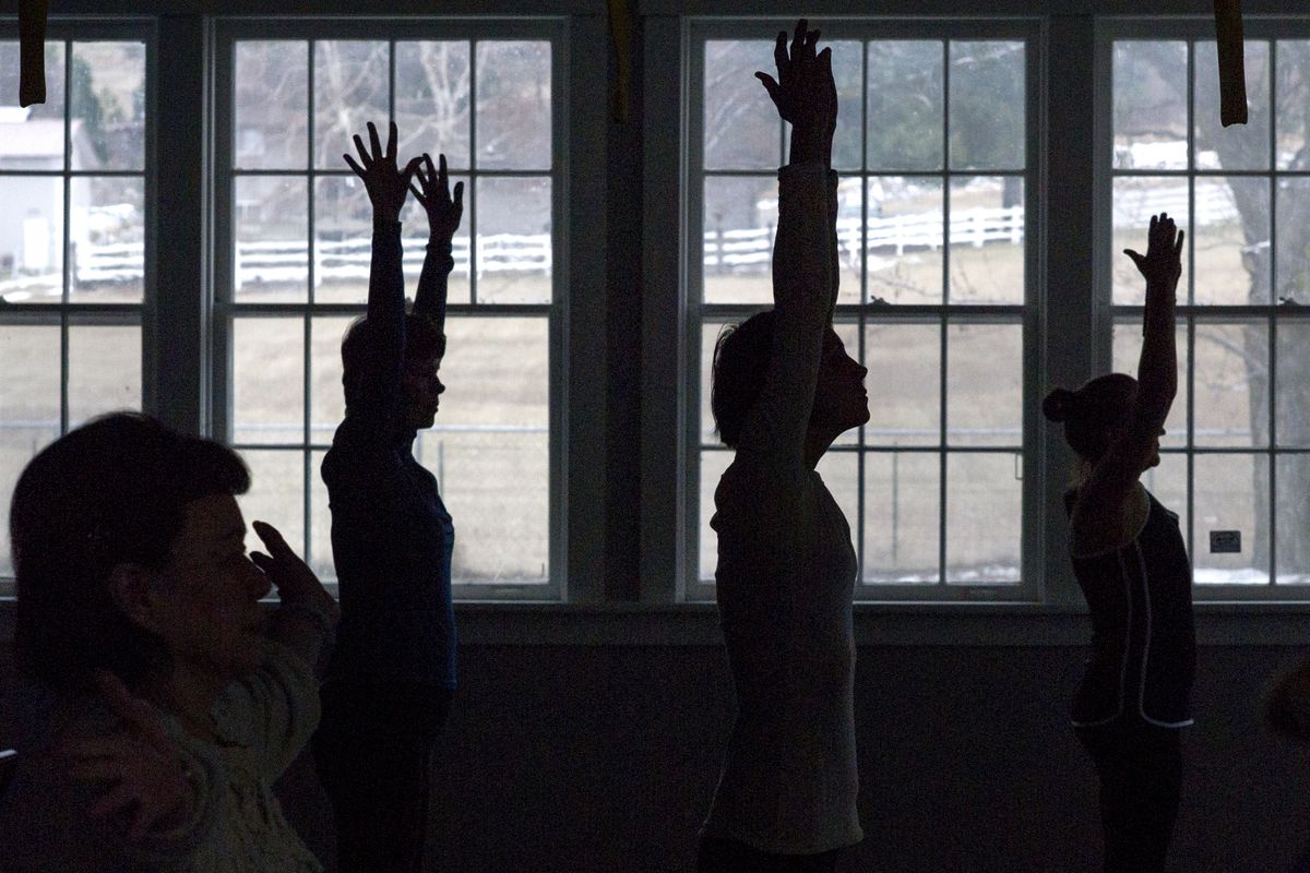 Patients participate in a yoga class at Cancer Care Northwest on Jan. 15. (Tyler Tjomsland)