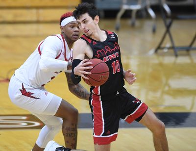 Eastern Washington guard Jacob Davison, who scored 31 points, works against Southern Utah guard John Knight III.  (Tyler Tjomsland/THE SPOKESMAN-RE)