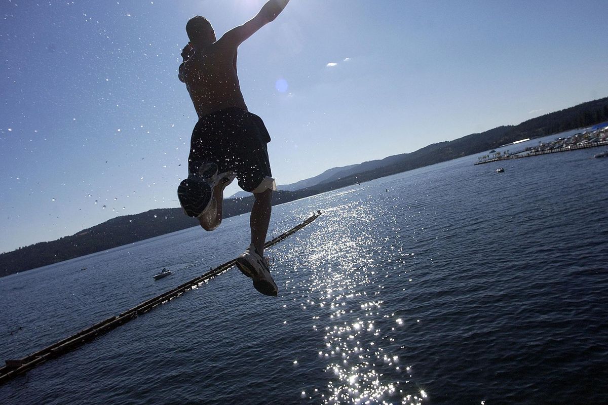 Tim Vogt, 16, of Spokane takes a long leap into Lake Coeur d'Alene from a height of more than 20 feet. Forecasters say this week is going to be hot hot HOT. (Jesse Tinsley / The Spokesman-Review)
