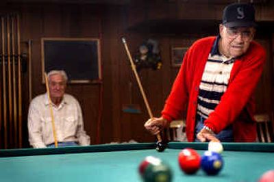 
Foster Houser, right, lines up a shot at the Spokane Valley Senior Center Friday. 
 (Holly Pickett / The Spokesman-Review)