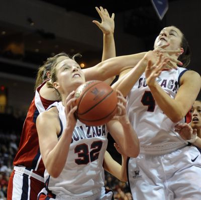 Kayla Standish of Gonzaga grabs an offensive rebound as her teammate Kelly Bowen takes a shot to the face during their game in the WCC Championship Tournament in Las Vegas on Saturday. Gonzaga pulled out a tight game to win in the final minutes and advance to the Monday Championship game.   (Christopher Anderson)