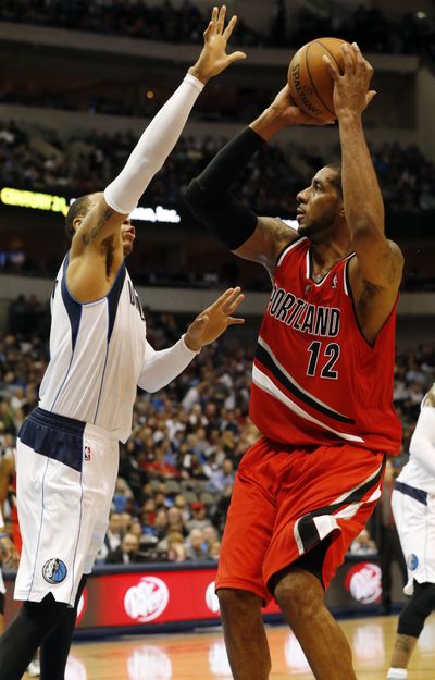 Trail Blazers forward LaMarcus Aldridge, right, recorded a double-double in Portland’s 103-98 loss at Dallas on Friday. (Associated Press)