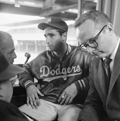Pitcher Sandy Koufax of Los Angeles Dodgers gestures as he tells reporters how he struck out 18 Chicago Cubs for a new National League day game record on April 24, 1962 in Chicago.  (Associated Press)