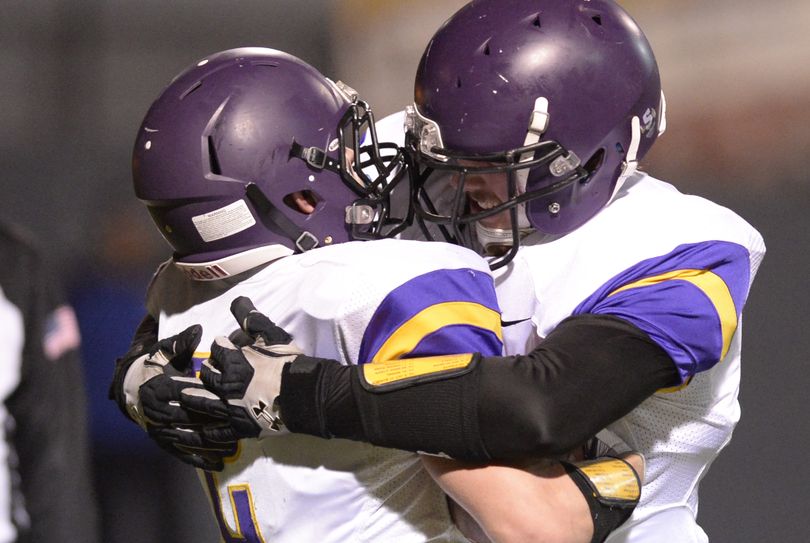 Rogers' tackle Kyle Eldredge, right, hugs running back Patrick Pullins, left, after Pullins rambled in for a touchdown against North Central in the second half Thursday, Oct. 30, 2014 at Joe Albi Stadium. Rogers beat the Indians 23-21, their first win in a long time. (Jesse Tinsley / The Spokesman-Review)