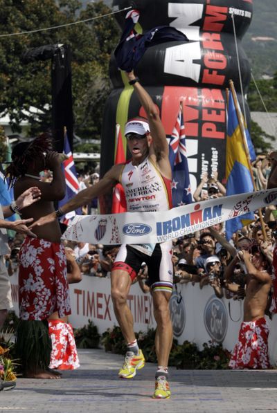 Craig Alexander, of Australia, crosses the finish line in Hawaii. (Associated Press)