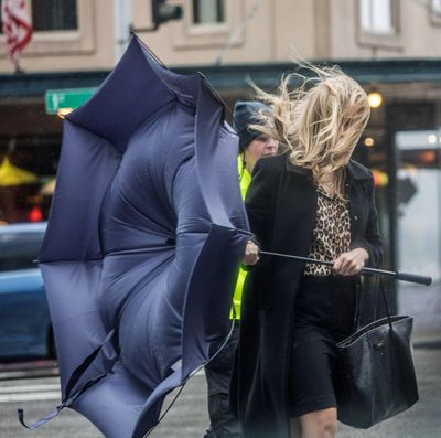 Pedestrians get battered crossing Pine Street on 1st Ave. in downtown Seattle by gusting winds coming off the water Friday, Oct. 14, 2016. (Steve Ringman / AP)
