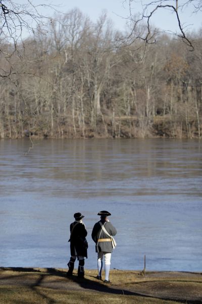 Revolutionary War re-enactors stand on the shore of the Delaware River.  (Associated Press / The Spokesman-Review)