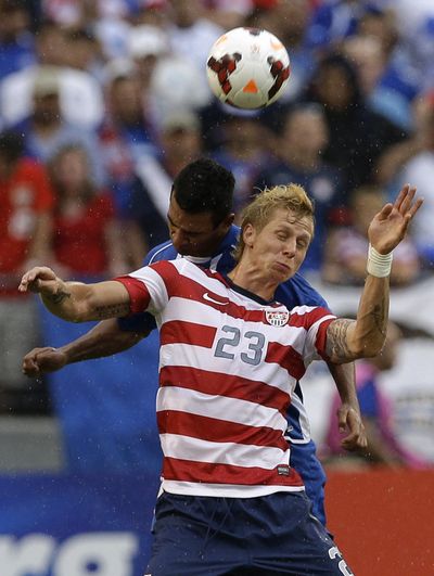American Brek Shea heads a ball in front of El Salvador's Xavier Garcia Orellana on Sunday. (Associated Press)
