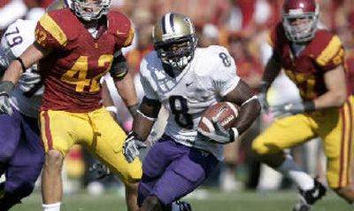 
Washington's Kenny James looks for some running room.
 (Associated Press / The Spokesman-Review)