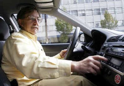 
David Shaw, a technical support specialist for nonprofit organizations, enters his PIN number on a keypad of a Flexcar shared vehicle while making a service call in Seattle this week. Car-sharing programs say business is booming, as more and more city dwellers are balking at the cost of car ownership and looking for alternatives. 
 (Associated Press / The Spokesman-Review)