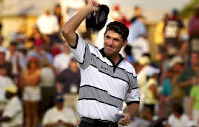 
Padraig Harrington, of Ireland, raises his cap to the crowd after winning the Honda Classic in a three-way playoff. 
 (Associated Press / The Spokesman-Review)