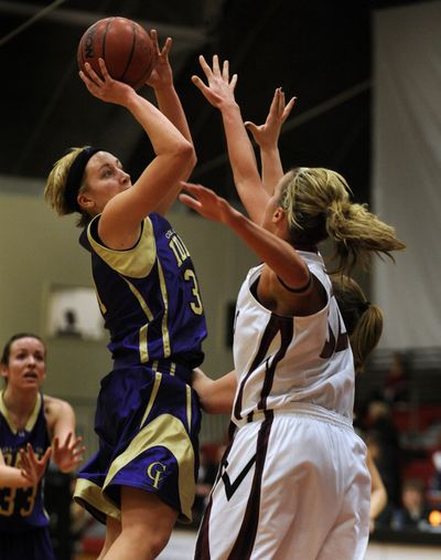 College of Idaho’s Nicole Gall takes a shot over Whitworth’s Cassie Pilkinton. (Colin Mulvany)