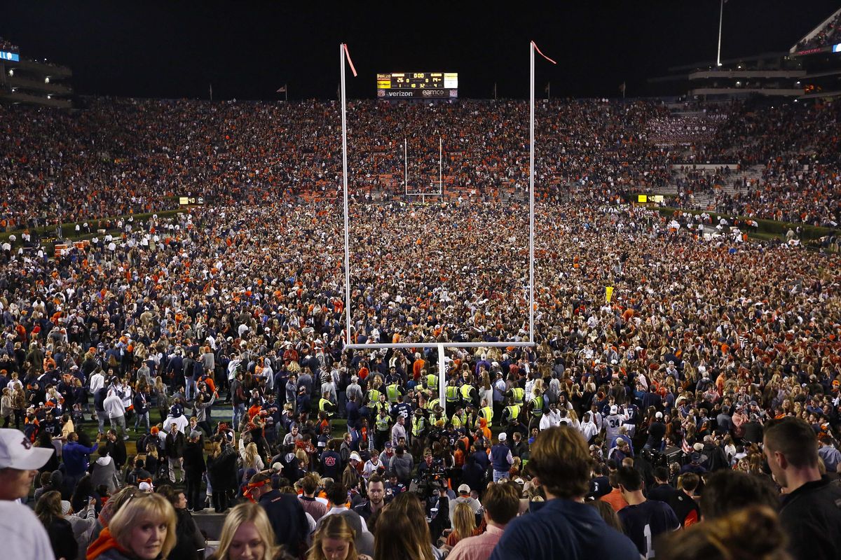Fans rush the field after Auburn defeated Alabama in the Iron Bowl NCAA college football game, Saturday, Nov. 25, 2017, in Auburn, Ala. What is most commonly referred to as major college football (aka NCAA Division I Bowl Subdivision or FBS) is compromised of 130 teams and 10 conferences. Seventy-seven of those teams are scheduled to play throughout the fall, starting at various times in September. The other 53, including the entire Big Ten and Pac-12, have postponed their seasons and are hoping to make them up later. That means no No. 2 Ohio State, No. 7 Penn State, No. 9 Oregon and six other teams that were ranked in the preseason AP Top 25. (Brynn Anderson)