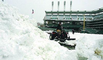 Cleveland grounds crew members clear the snow off Jacobs Field that forced postponement of a four-game Mariners series.
(Associated Press / The Spokesman-Review)