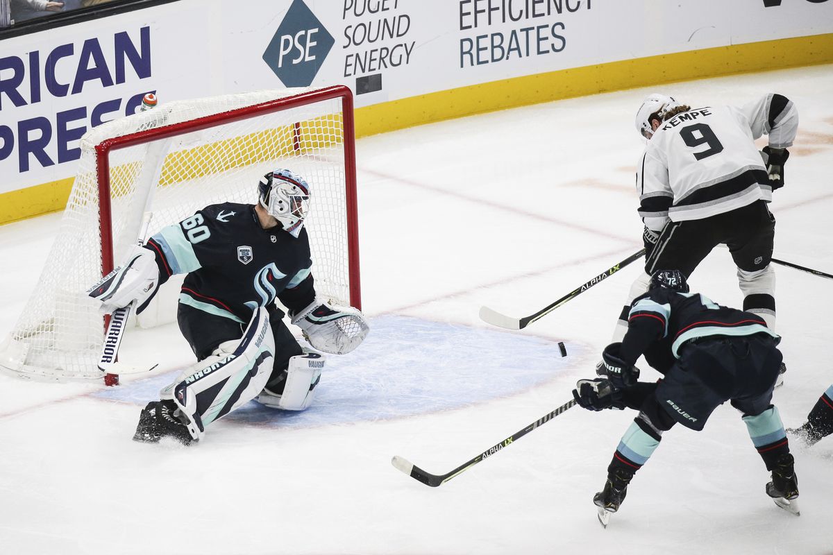 Los Angeles Kings center Adrian Kempe (9) chips the puck in past Seattle Kraken goaltender Chris Driedger (60) to score during the first period of an NHL hockey game, Saturday, Jan. 15, 2022, in Seattle.  (Lindsey Wasson)