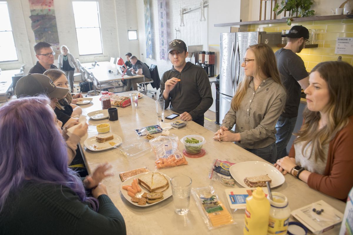 Independent businesspeople gather  for their weekly potluck lunch at Fellow Coworking on Thursday, April 5, 2018. Coworking spaces like Fellow Coworking fill  with artists, writers, advertising and marketing creatives, and social media entrepreneurs who want a professional space in which to work. (Jesse Tinsley / The Spokesman-Review)