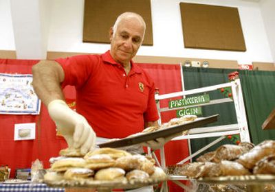 
Alessandro Chiappe puts out pastries at Festa Italiana. 
 (The Spokesman-Review)