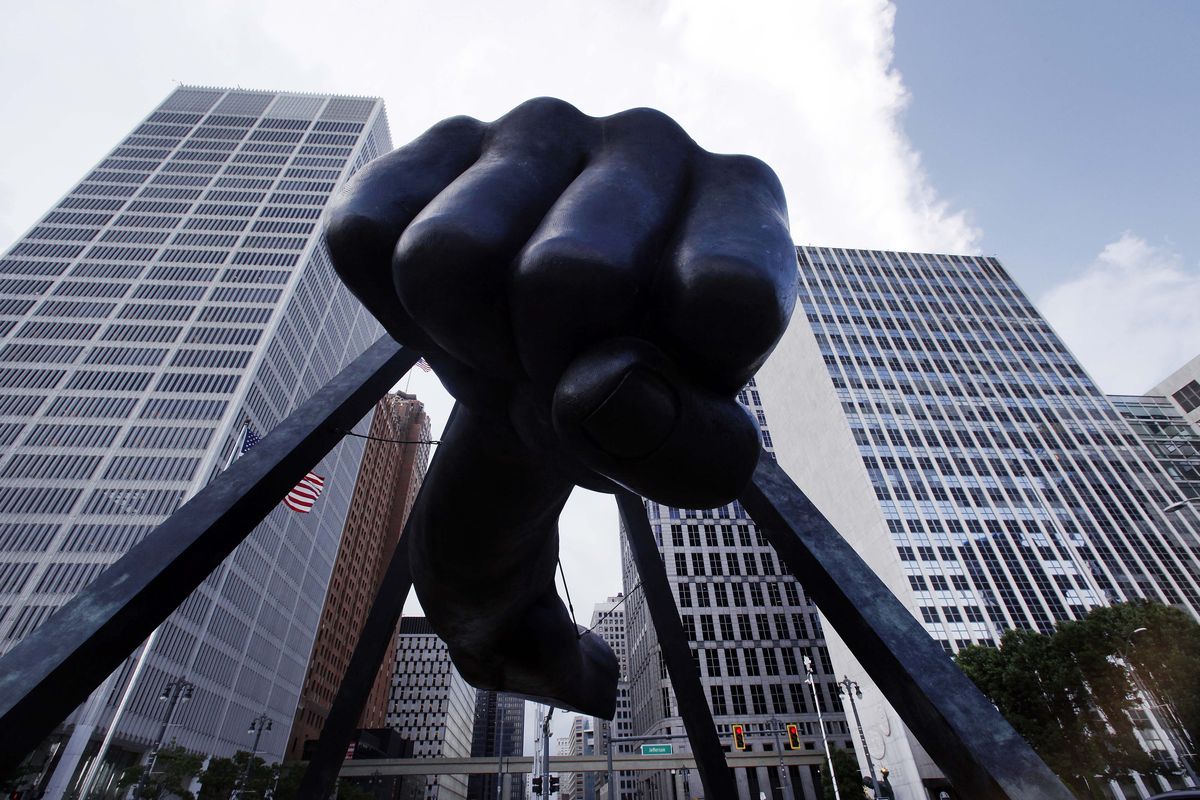 The Detroit skyline rises behind the Monument to Joe Louis, also known as “The Fist,” on Thursday. (Associated Press)