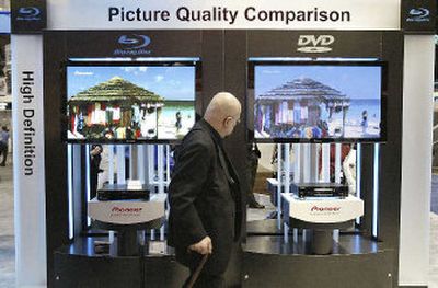 
An attendee compares the difference between Blu-ray format DVD, left, and regular DVD, right, at the Pioneer booth at the Consumer Electronic Show.
 (Associated Press / The Spokesman-Review)