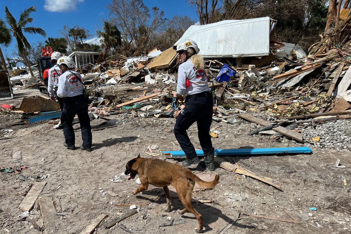 Members of the Virginia Task Force 2 urban search and rescue team look for victims at the Red Coconut RV Park in Fort Myers Beach, Fla., on Wednesday. MUST CREDIT: Photo for The Washington Post by Octavio Jones  (Octavio Jones/For The Washington Post)