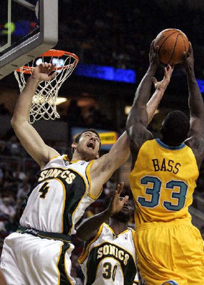 
Seattle's Nick Collison, left, is late to a rebound already grabbed by the Hornets' Brandon Bass. 
 (Associated Press / The Spokesman-Review)