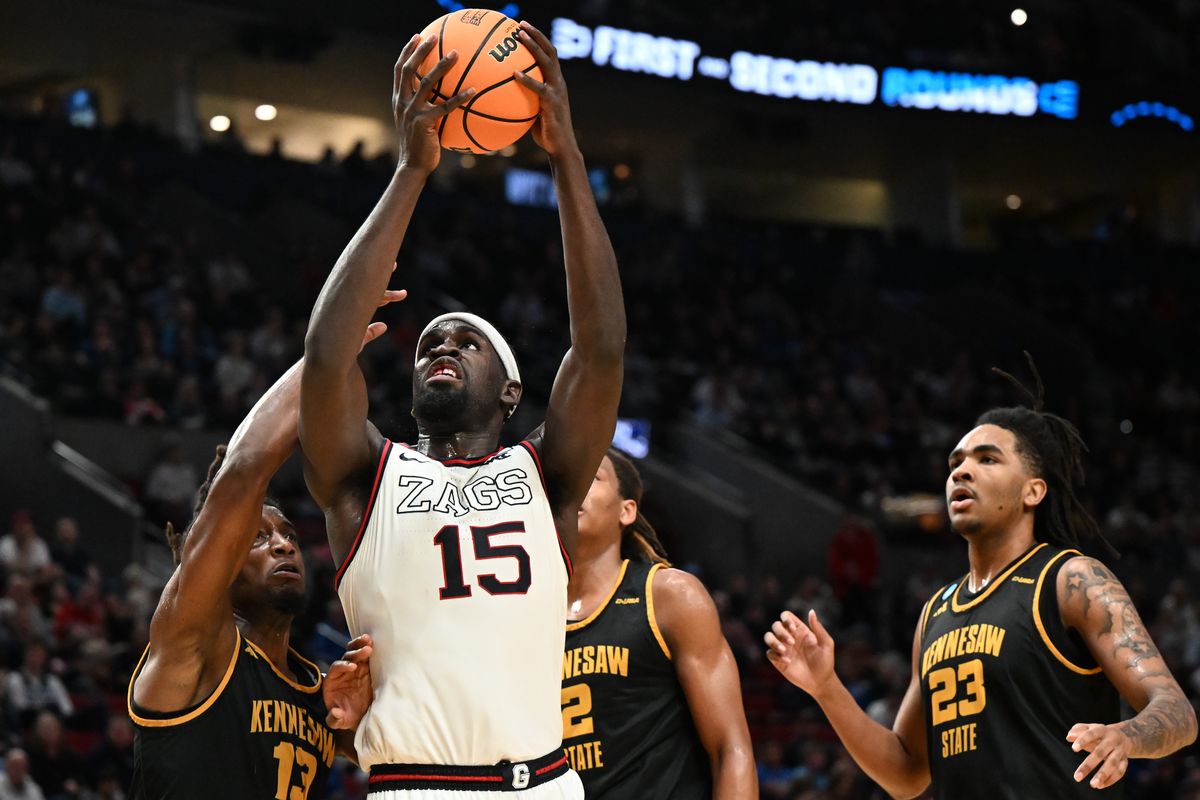 Gonzaga Bulldogs forward Graham Ike (15) fights through contact from Kennesaw State Owls forward Braedan Lue (13) during the second half of the first round of the NCAA basketball tournament on Thursday, Mar 19, 2026, at Moda Center in Portland, Ore. The Gonzaga Bulldogs won the game 73-64.  (Tyler Tjomsland/The Spokesman-Review)
