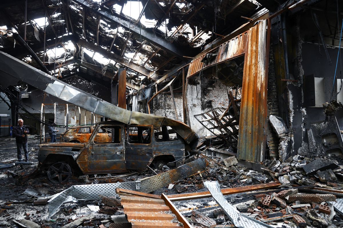 People document the interior of a car repair shop and dealership damaged by a strike in Tehran, Iran, on Saturday, amid the U.S.-Israeli conflict with Iran. (West Asia New Agency via Reuters)
