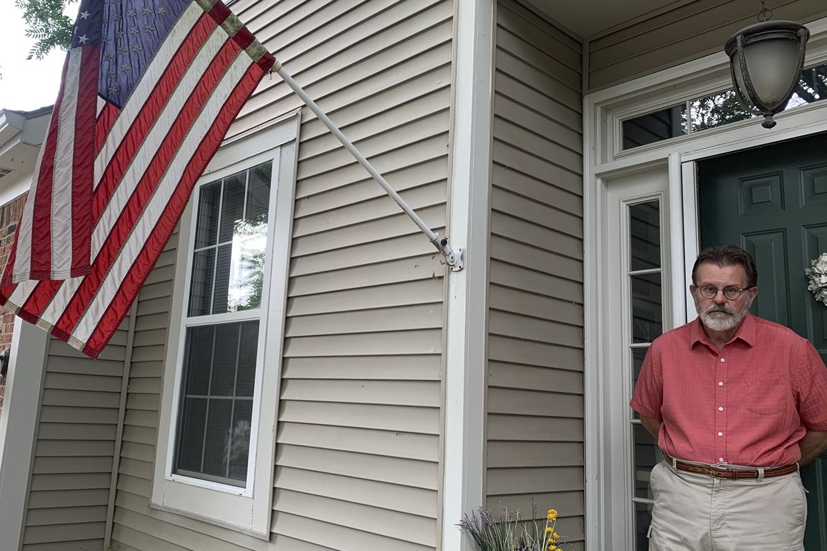 Richard Dayton stands in front of his house as he poses for a photograph, Friday, July 17, 2020, in Columbus, Ohio. State and local election officials across the country are trying to recruit younger workers to staff polling places on Election Day in November. The effort is driven by concern that many traditional poll workers will be too worried about catching the coronavirus to show up.  (Farnoush Amiri)