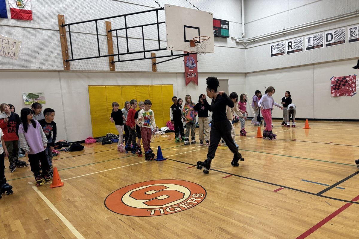 Kiara Conklin shows her students some roller skate moves.