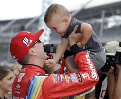 Kyle Busch talks with his son, Brexton, after winning the pole for the NASCAR Cup auto race at Indianapolis Motor Speedway, in Indianapolis on Saturday, July 22, 2017. (Darron Cummings / Associated Press)