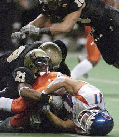 
Idaho's Chris Smith (21) and Shiloh Keo make the tackle on Boise State's Ian Johnson during first-quarter action on Saturday at the Kibbie Dome in Moscow. 
 (Roger Ames Special to / The Spokesman-Review)