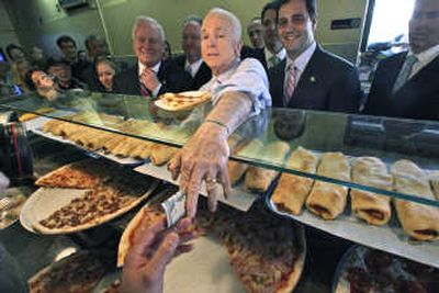 
Republican presidential candidate, Sen. John McCain, R-Ariz., pays for a slice of pizza at Verrazano Pizza after campaigning in the Brooklyn borough of New York on Thursday.Associated Press
 (Associated Press / The Spokesman-Review)