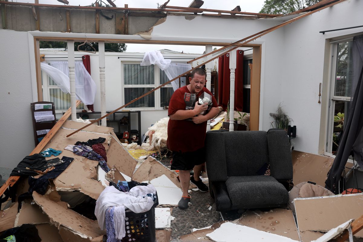 FORT MYERS, FLORIDA - OCTOBER 09: Robert Haight salvages what he can from his home after what appeared to be a tornado tore the roof off before Hurricane Milton