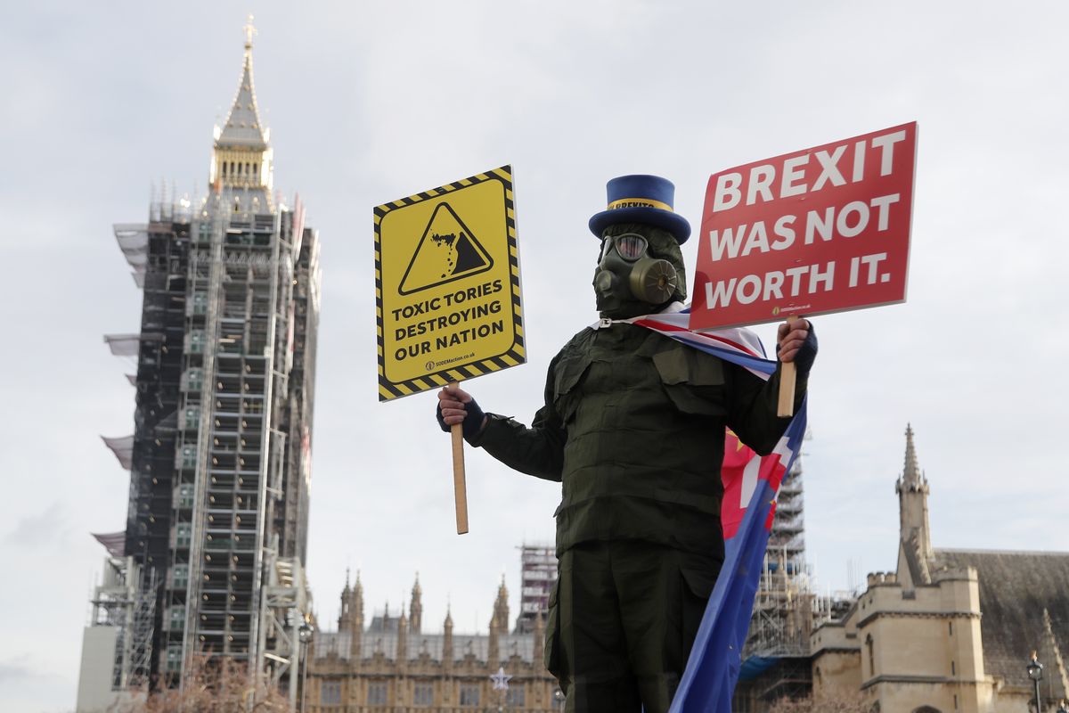 A pro EU protestor stands in parliament square in front of Parliament during the debate in the House of Commons on the EU (Future Relationship) Bill in London, Wednesday, Dec. 30, 2020.The European Union