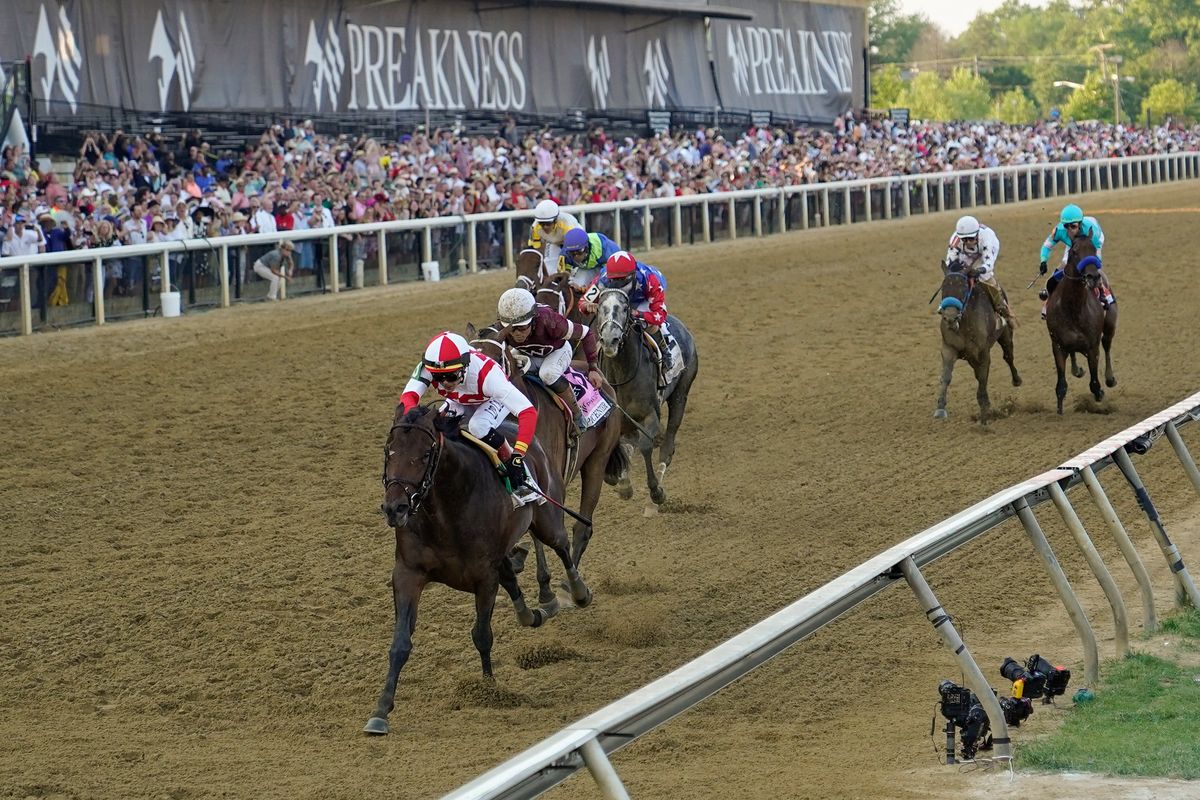 Jose Ortiz, left, atop Early Voting, wins the 147th running of the Preakness Stakes horse race at Pimlico Race Course, Saturday, May 21, 2022, in Baltimore.  (Julio Cortez)