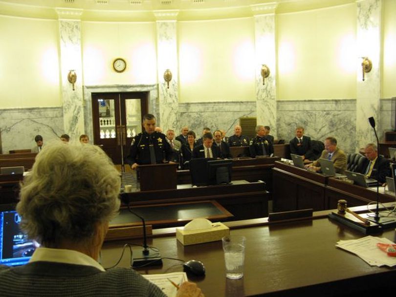 Idaho State Police Director Col. Jerry Russell begins his budget pitch to the Joint Finance-Appropriations Committee on Thursday; at left is JFAC Co-Chair Maxine Bell, R-Jerome, who was presiding. Russell said six detective positions and nine patrol officer jobs are being held vacant due to budget cuts. (Betsy Russell)