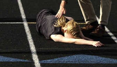 
North Central's Stephanie Krebs collapses at the finish line after winning the 400-meter run in the Greater Spokane League championship quad meet.North Central's Stephanie Krebs collapses at the finish line after winning the 400-meter run in the Greater Spokane League championship quad meet.
 (Brian Plonka/Brian Plonka/ / The Spokesman-Review)