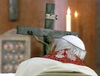 
In this frame made from CTV Vatican television, Pope John Paul II holds a crucifix as he follows on video-link the Via Crucis (Way of the Cross) torchlight procession in front of Rome's Colosseum from his chapel at the Vatican.
 (Associated Press / The Spokesman-Review)