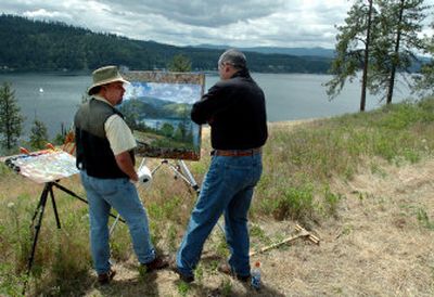
Thomas Kinkade, left, talks with builder Steve Torres on a hillside overlooking Lake Coeur d'Alene where a development group, including Torres, will soon build a series of homes based on paintings by Kinkade. The site is east of Coeur d'Alene. 
 (Jesse Tinsley / The Spokesman-Review)