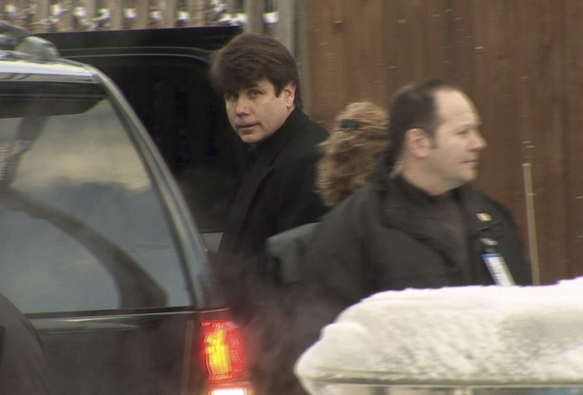 Illinois Gov. Rod Blagojevich, center, leaves his home  Wednesday, a day after his arrest on federal corruption charges.  (Associated Press / The Spokesman-Review)