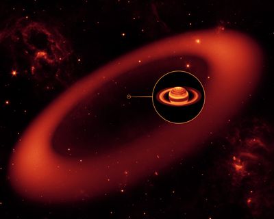 ORG XMIT: LA101 This artist's rendering released by NASA's Jet Propulsion Laboratory on Tuesday Oct. 6, 2009 shows the biggest but never-before-seen ring around Saturn, spotted by NASA's Spitzer Space Telescope. The inset shows an enlarged image of Saturn, as seen by the W.M. Keck Observatory at Mauna Kea, Hawaii, in infrared light. The bulk of the ring material starts about six million kilometers (3.7 million miles) away from the planet and extends outward roughly another 12 million kilometers (7.4 million miles). The newly found ring is so huge it would take 1 billion Earths to fill it, JPL said. (AP Photo/Artist's Rendering courtesy NASA's Jet Propulsion Laboratory) (The Spokesman-Review)